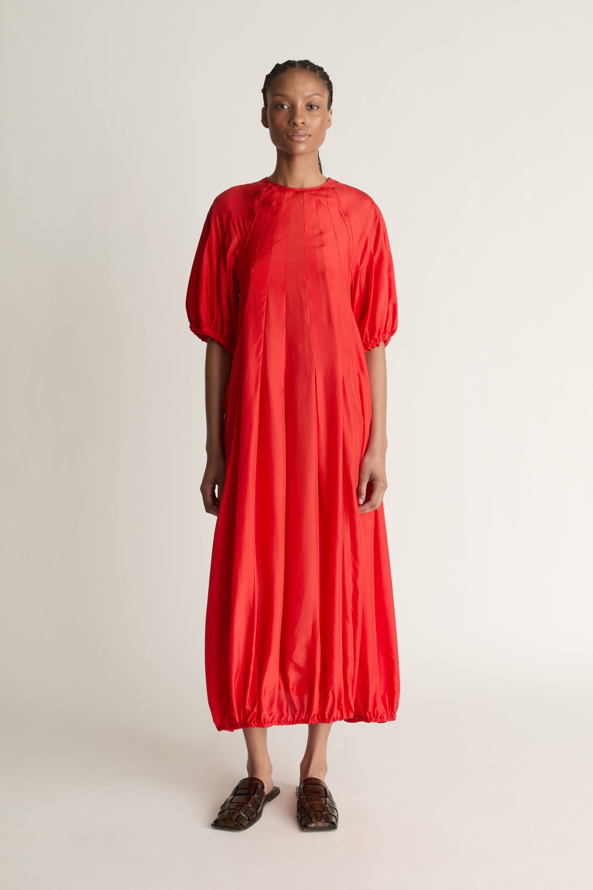 Person wearing a red dress on a white background