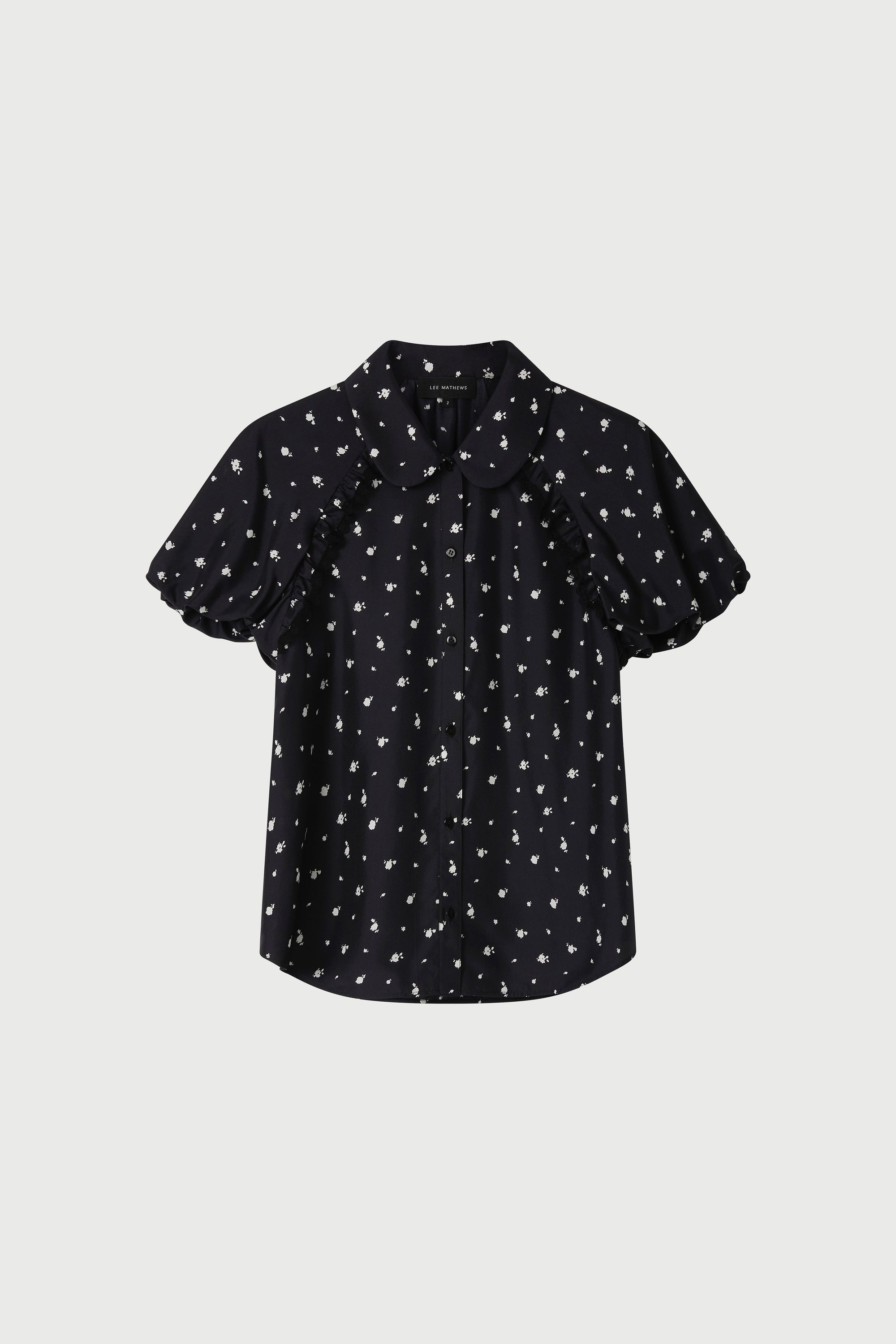 Black blouse with white pattern on a light gray background