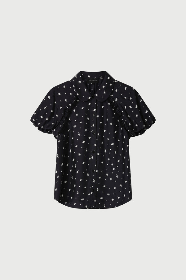 Black blouse with white pattern on a light gray background